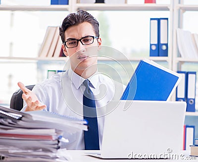 Businessman with excessive work paperwork working in office Stock Photo