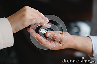 businessman exchange handing over the car keys for to a young women. Stock Photo