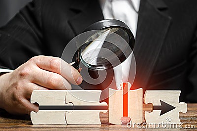 Businessman explores a wrong puzzle piece. Finding the cause and fixing the problem. Failure, wrong business model. Stock Photo