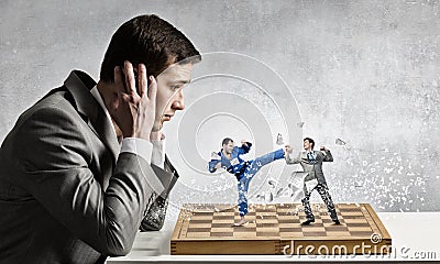 Businessman fighting on the chessboard Stock Photo