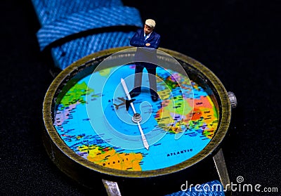 Businessman figurine on global map watch. Worldwide business concept. Stock Photo