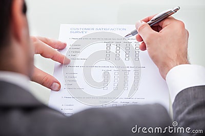 Businessman filling customer survey form Stock Photo