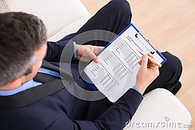 Businessman filling customer survey form Stock Photo