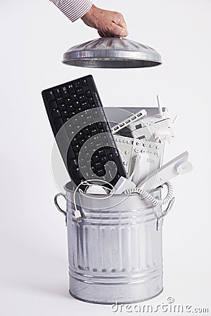 Businessman Filling Garbage Can With Obsolete Office Equipment Stock Photo