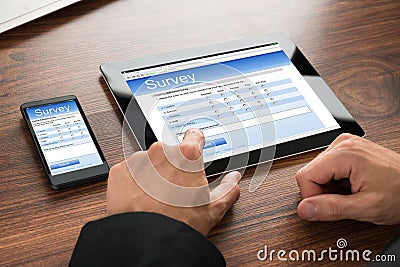 Businessman filling survey form Stock Photo