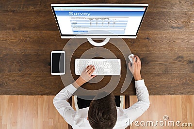 Businessman Filling Survey Form On Computer Stock Photo