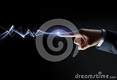 Businessman finger connecting to lightning Stock Photo