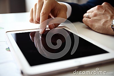 Businessman finger pointing to the screen of a tablet Stock Photo