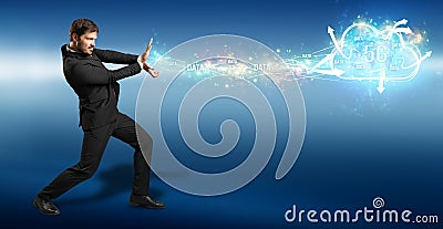 Businessman firing data like a superpower into a 5G cloud Stock Photo