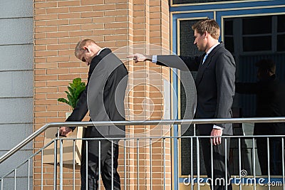 Businessman Firing Employee Outside Office Stock Photo