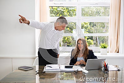 Businessman Firing Upset Female Employee Stock Photo