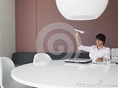 Businessman Flying Airplane At Office Desk Stock Photo