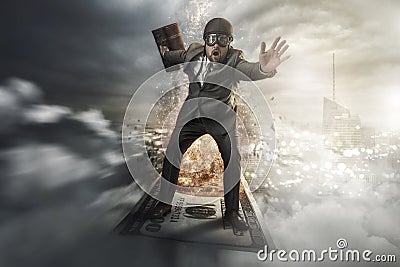 Businessman flying on top of money Stock Photo