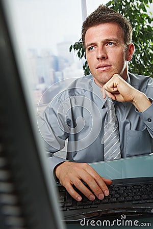 Businessman focusing on problems in office Stock Photo