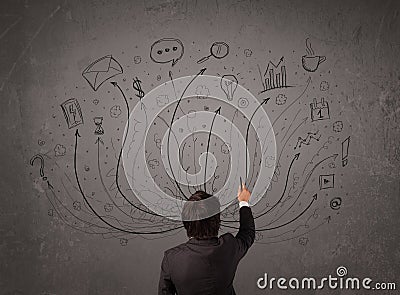 Businessman in front of a chalkboard deciding with arrows and si Stock Photo