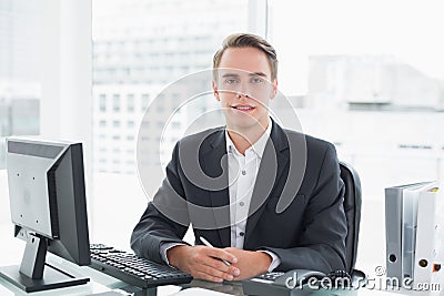 Businessman in front of computer at office desk Stock Photo