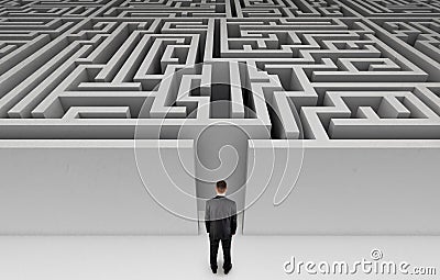 Businessman in front of a huge maze Stock Photo