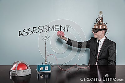 Businessman In Futuristic Helmet Holding Brain By Assessment Text Stock Photo