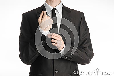 Businessman and gesture topic: a man in a black suit with a tie coat straightens his arms isolated on a white background in studio Stock Photo
