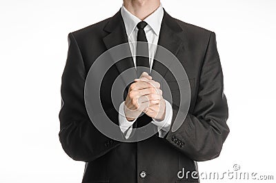 Businessman and gesture topic: a man in a black suit with a tie folded his hands in front of him and praying, meditating Stock Photo