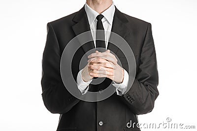 Businessman and gesture topic: a man in a black suit with a tie folded his hands in front of him and praying, meditating Stock Photo