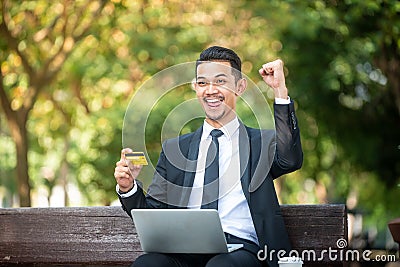 Businessman gets a Good deal on the internet. E-commerce and online purchase. Outdoor setting Stock Photo