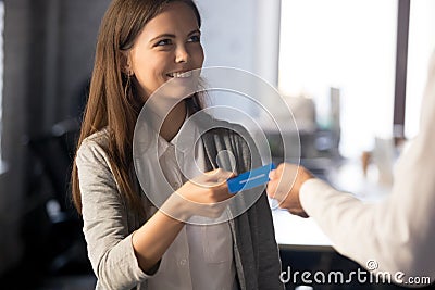 Businessman give business card to excited female employee Stock Photo