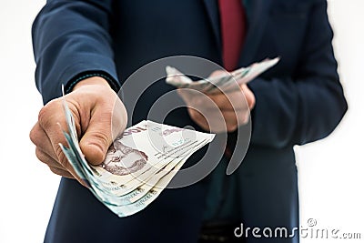 Businessman gives bribe or pay, in isolation. UAH. 1000 new banknote Ukrainian money Stock Photo
