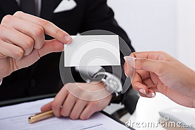 Businessman Giving Business Card To Colleague Stock Photo