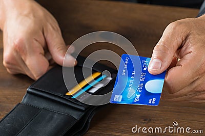 Businessman Giving Credit Card From Wallet Stock Photo