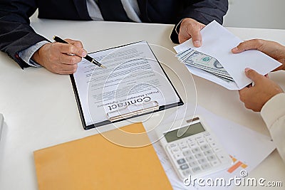 Businessman giving money while making deal to agreement a real e Stock Photo