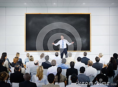 Businessman Giving Presentation in Board Room Stock Photo