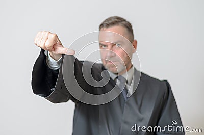 Businessman giving a thumbs to side gesture Stock Photo