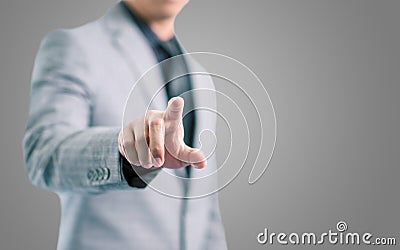 Businessman in gray suit is pointing his finger to touch the screen concept Stock Photo