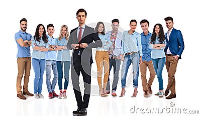 Businessman group leader buttoning suit in front of his team Stock Photo