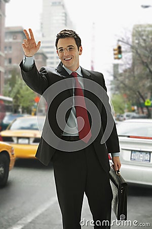 Businessman Hailing a Taxi Stock Photo