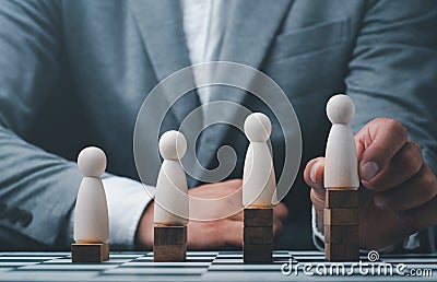 Businessman hand choose people with outstanding ability from the crowd,Successful team leader concept Stock Photo