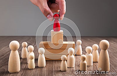 Businessman hand choose people standing out from the crowd Stock Photo