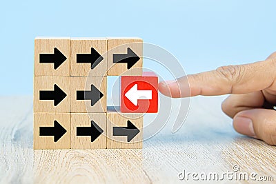 Businessman hand choose red wooden toy blog with arrow icons concept. Stock Photo