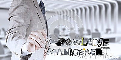 Businessman hand drawing KNOWLEDGE MANAGEMENT Stock Photo