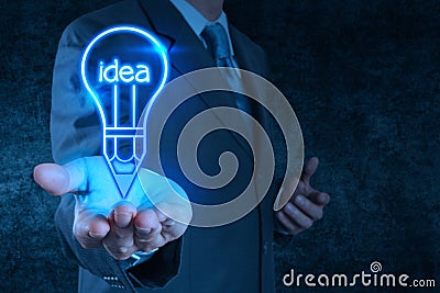 Businessman hand draws lightbulb Stock Photo
