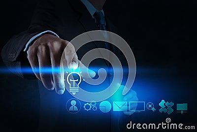 Businessman hand draws lightbulb with new computer Stock Photo