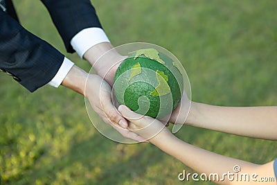 Businessman hand giving Earth globe to little boy as Earth day concept. Gyre Stock Photo