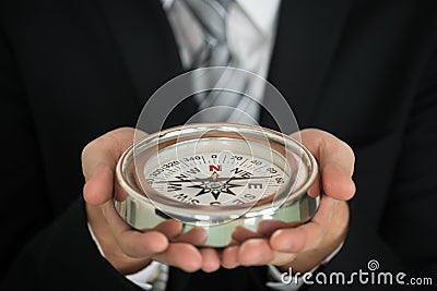 Businessman Hand Holding Compass Stock Photo