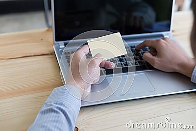 Businessman hand holding a Credit card intent to made a online p Stock Photo