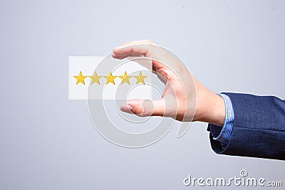 Businessman hand holding five stars isolated on background. Business concept. Stock Photo Stock Photo