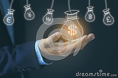 Businessman hand holding money bag with hologram on dark background, currency for investment and business concept Stock Photo