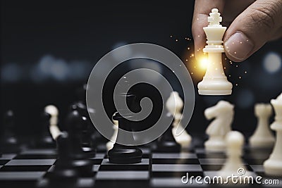 Businessman hand holding and moving white king chess figure with competitor to success play. Business management competition and Stock Photo