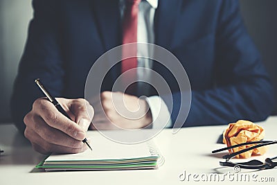 Businessman hand notepad and pen on table Stock Photo