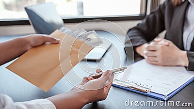 Businessman hand offer bribes money in envelope for signing in a contract of business project, Government officials refused, Stock Photo